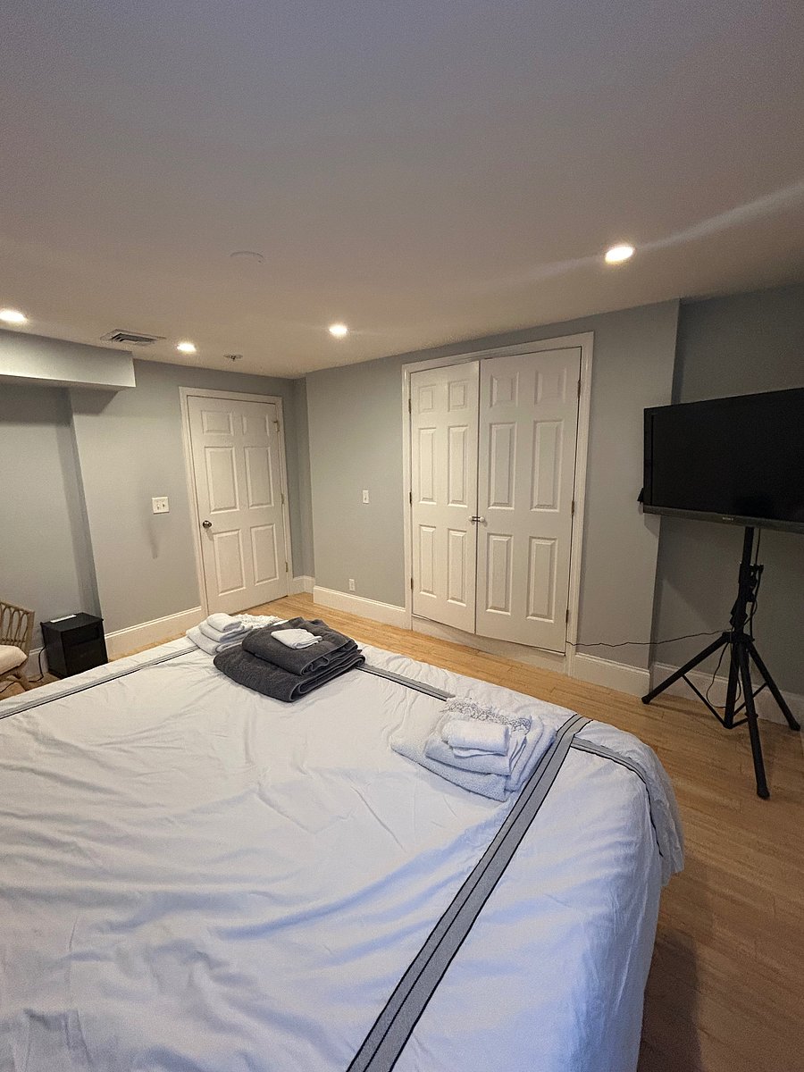 Room 1 features a king-size bed, large closet, TV, and cozy papasan chair.