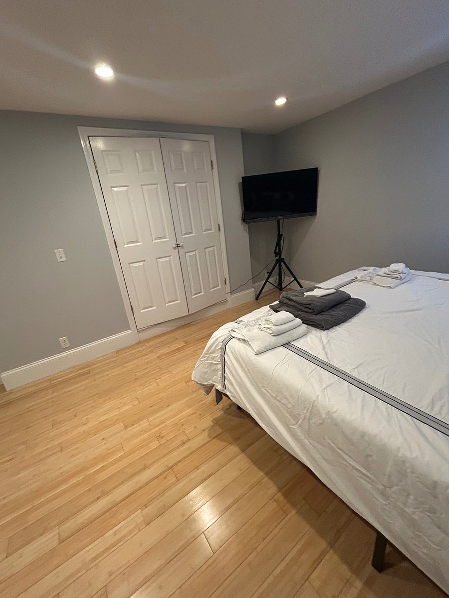 Room 1 features a king-size bed, large closet, TV, and cozy papasan chair.
