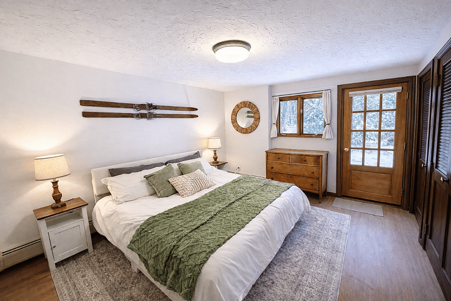 King bed in primary bedroom, door walks out to patio with table and chairs for two. Laundry room off primary bedroom.