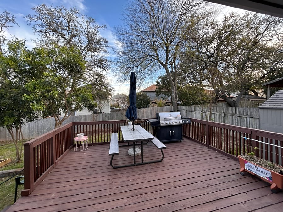 Deck with table, umbrella and gas grill