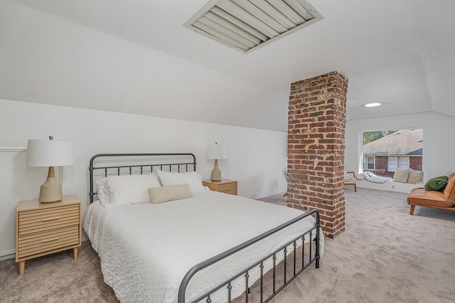 Upstairs queen bed with desk area and hangout space