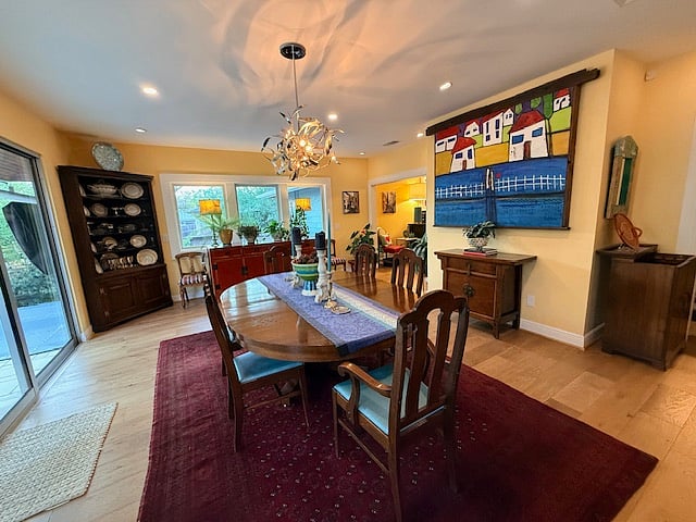 dining room with glass slider to deck/pool
