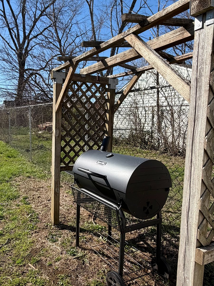 Charcoal grill inside fenced yard