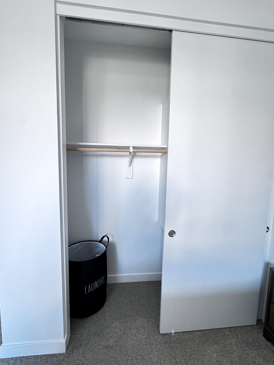 Bedroom 1 closet with hamper