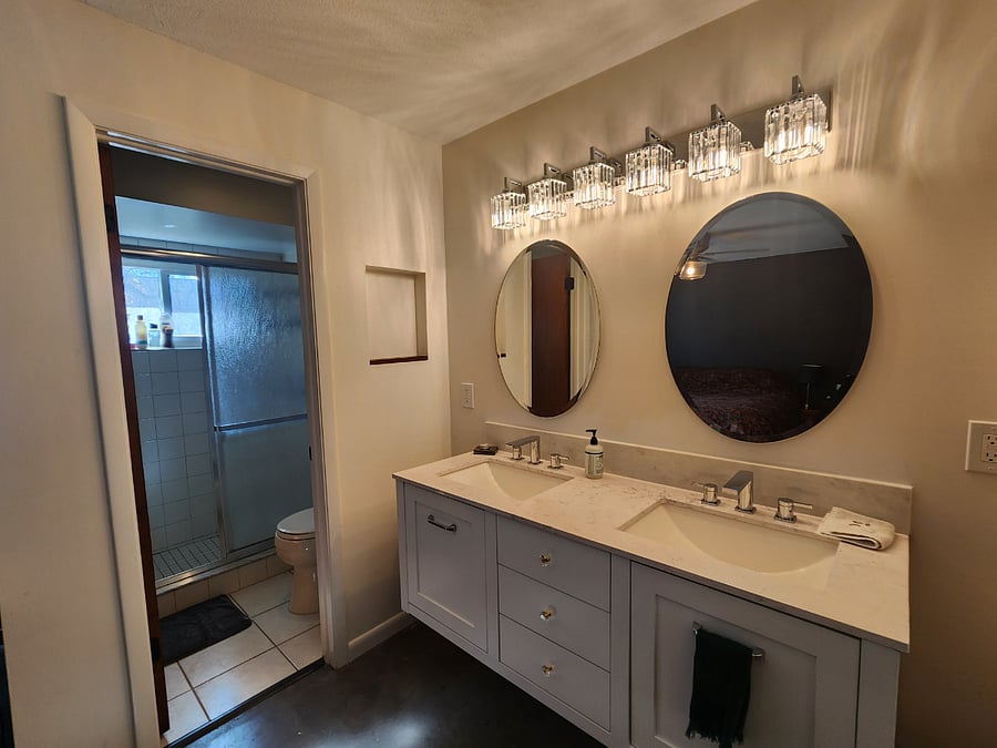 En suite primary bath. Stand up shower with a rain shower head and separate double vanity.