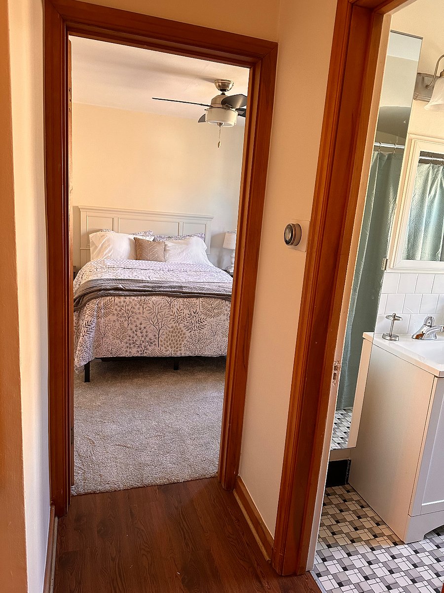 Quiet, inviting bedroom with ceiling fan and great natural light