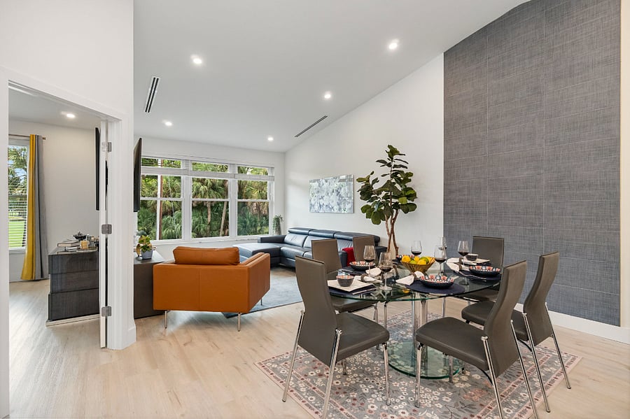 Dining Area with Tall Ceilings and Tile accent Wall