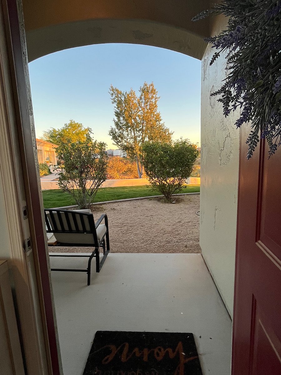 View from the front door with a glider near rose garden
