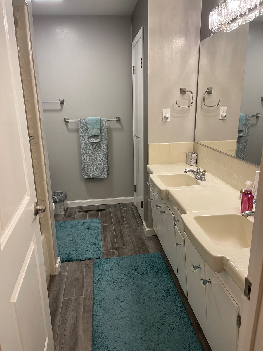 Shared bathroom has a large double vanity with plenty of space for your personal items.
