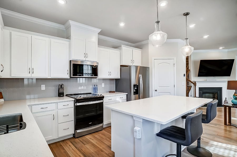 Kitchen with island and two bar stools