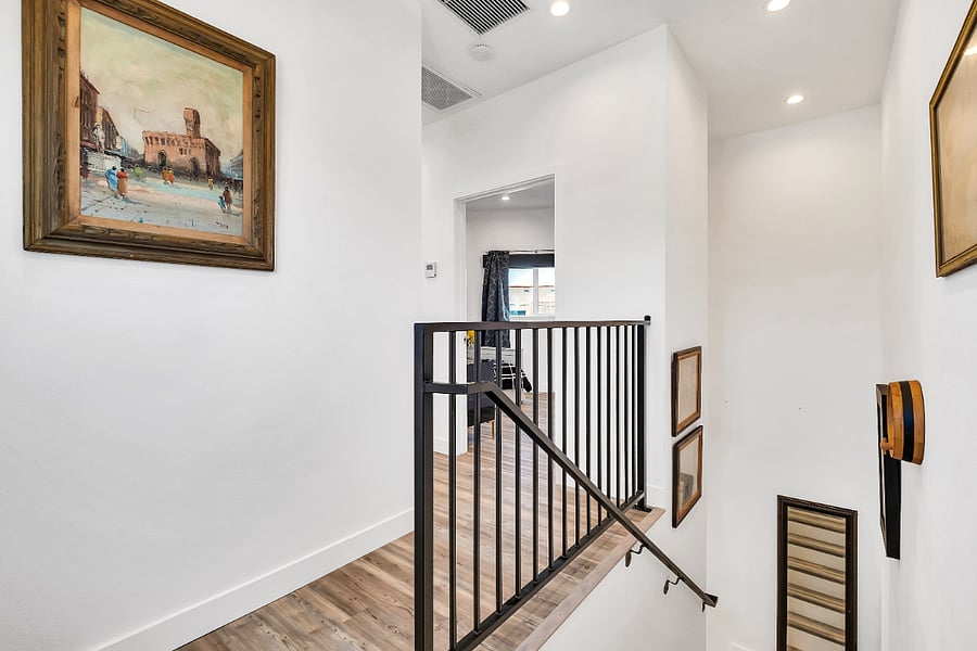 These original stairs lead to the second-floor bedrooms and bathrooms. A secure handrail is provided on the right side