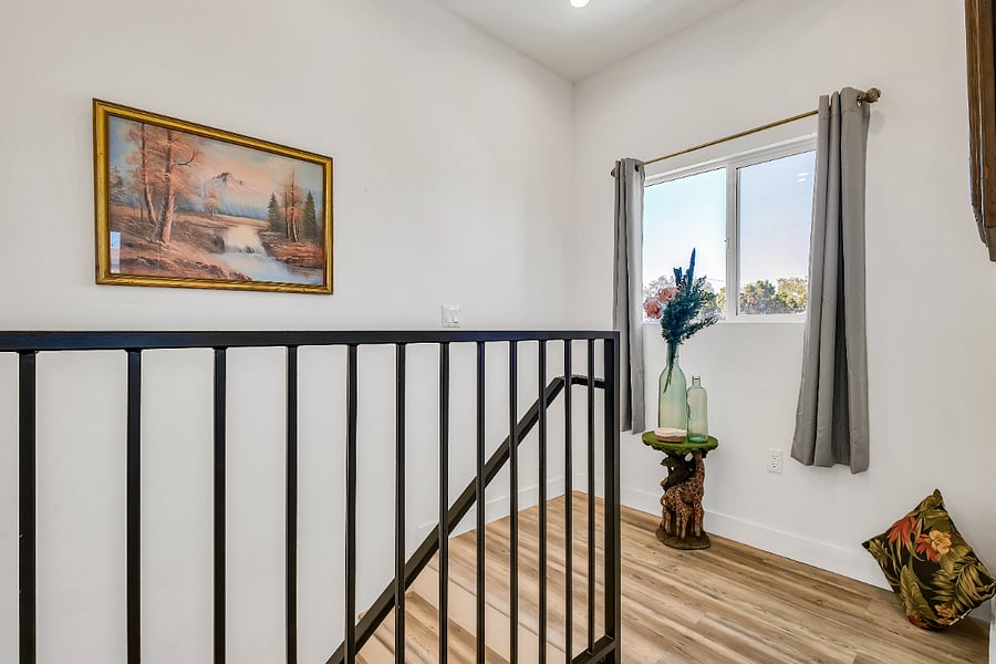 Flooded with natural light, the soaring windows above the staircase brighten the home