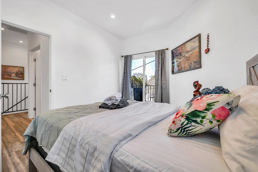 Unwind in this spacious master suite featuring blackout curtains and a cozy private balcony