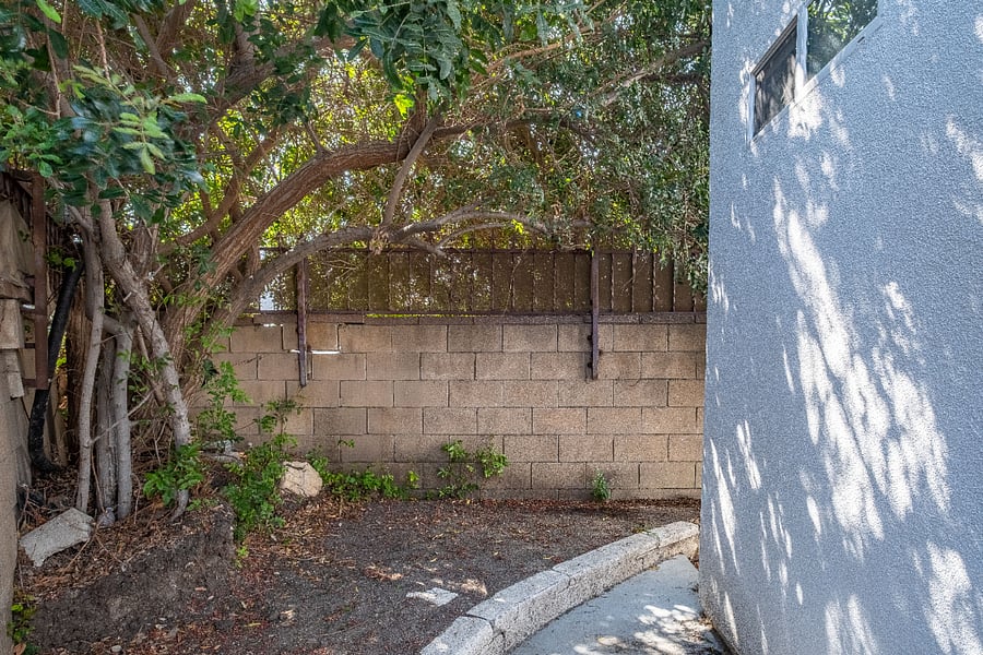 This private, tree-lined backyard offers a peaceful sanctuary right outside your door