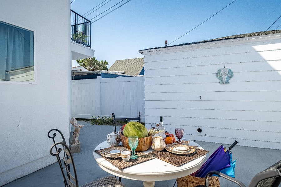 Gather around this outdoor dining table with seating for the whole family, perfect for crisp evenings