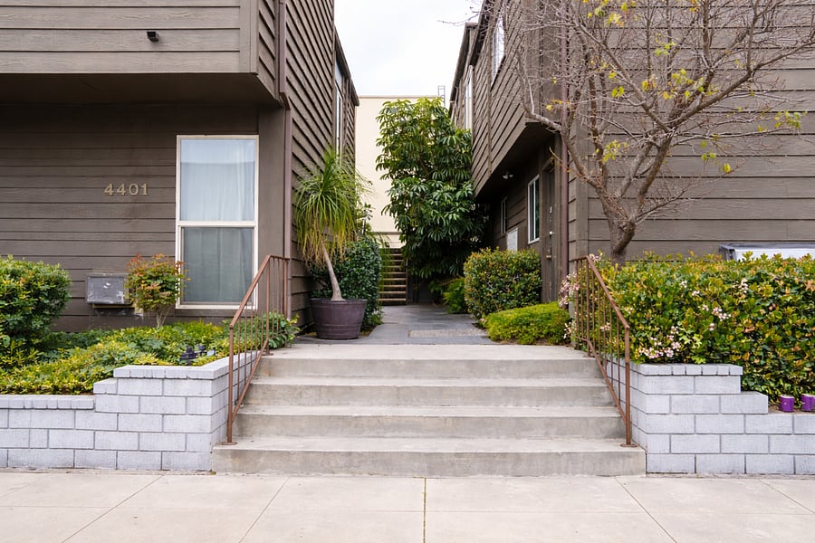 Lush greenery surrounding the building creating a calm residential setting.