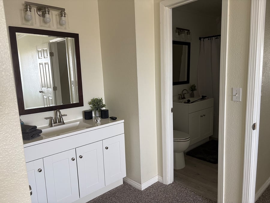 A new, oversized sink vanity in the primary bedroom provides a dedicated and stylish space for daily preparations.