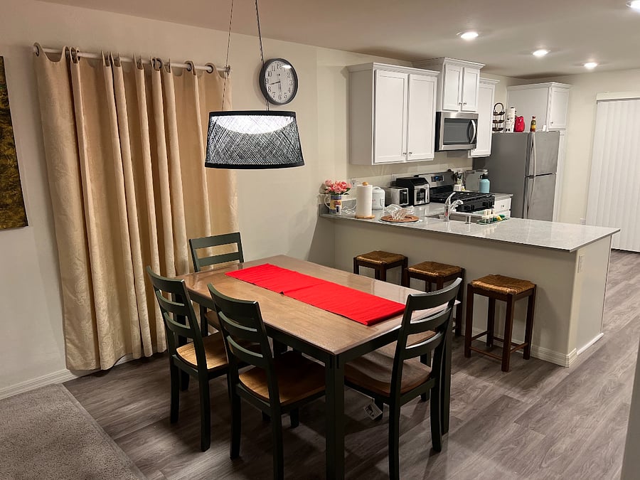 Dining Area, with 6 person Dining table, and countertop with 3 bar stool chair. 