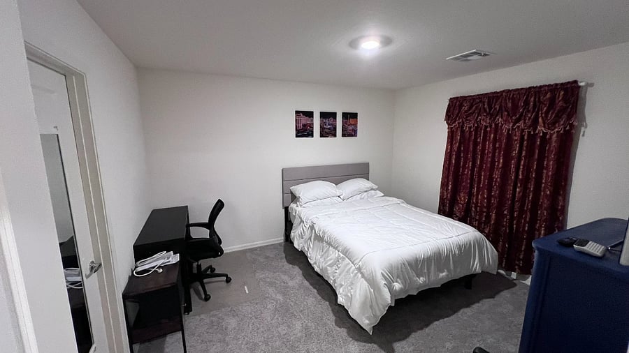 Master bedroom with Queen Size bed, Office desk, Cabinet, Book shelf, and TV.