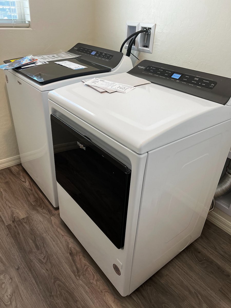 Laundry room with brand new washer and dryer units.