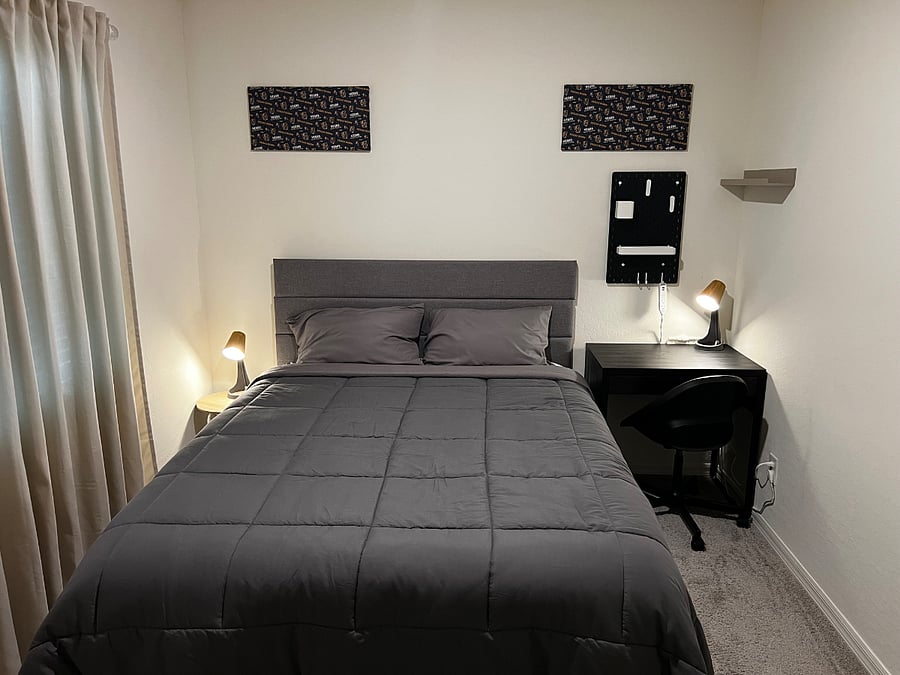 Room 2 - Queen Size Bed, Side Lamps, Desk Table and swivel chair.