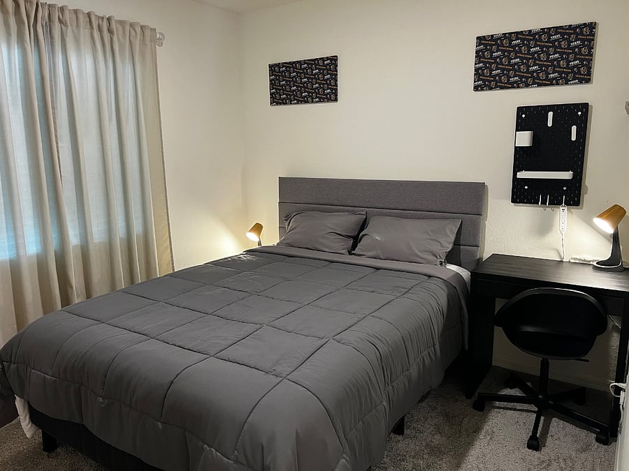 Room 2 - Queen Size Bed, Side Lamps, Desk Table and swivel chair.