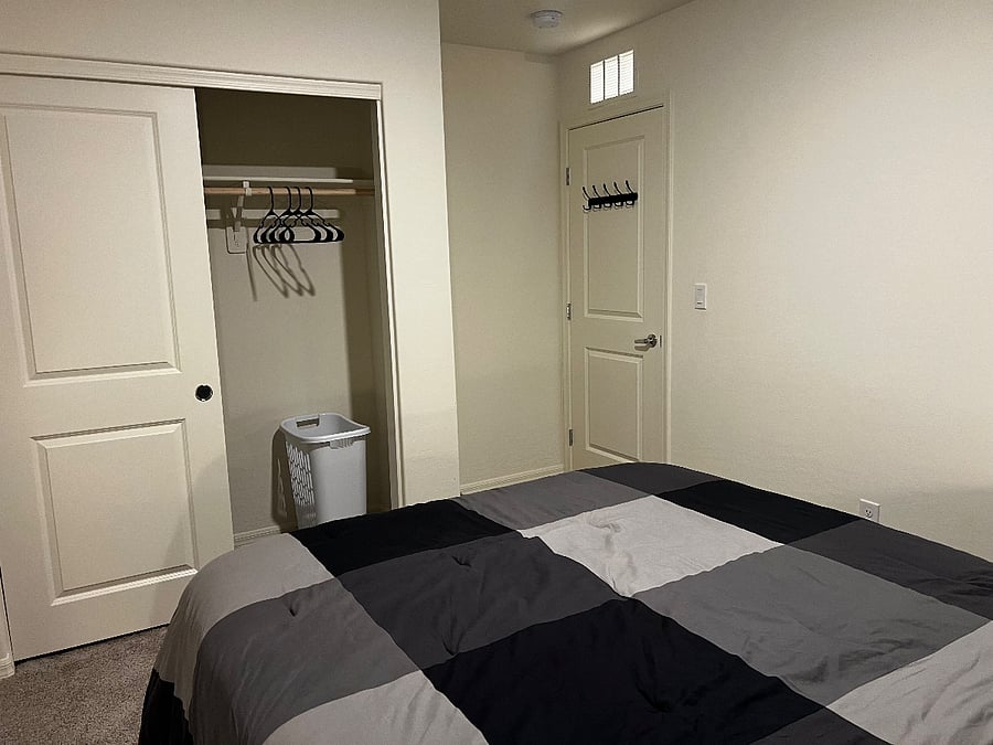 Room 1 - Storage Closet with hangers and hamper.