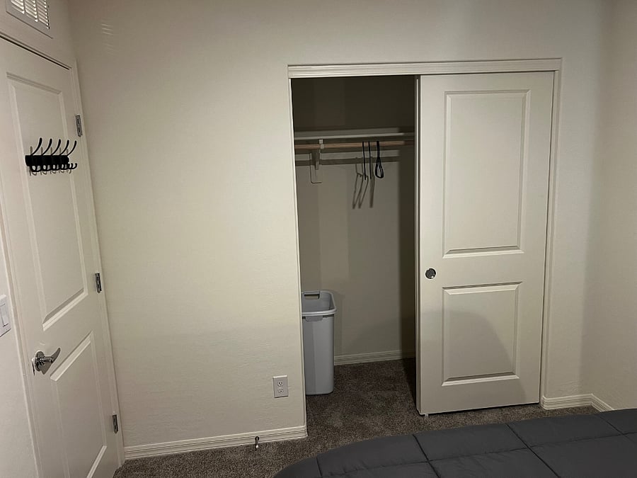 Room 2 - Storage Closet with hangers and hamper.