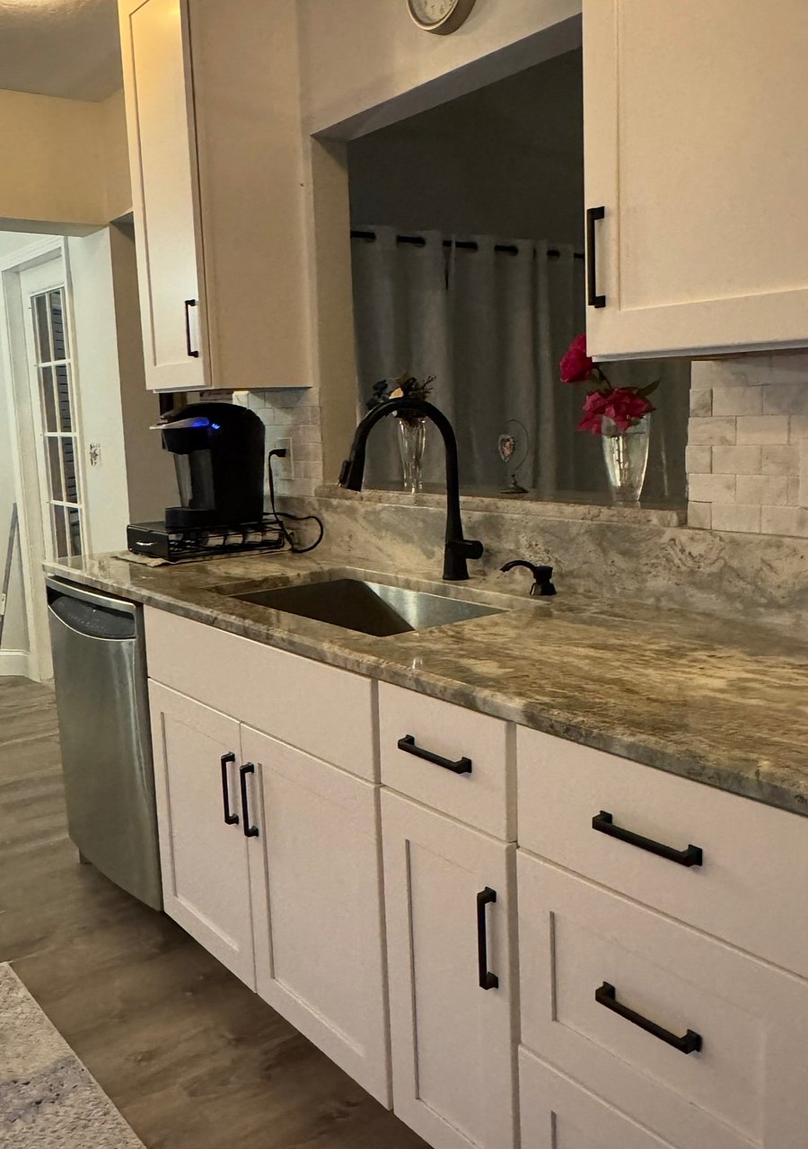 Granite Countertop with matching backsplash. New sinlk