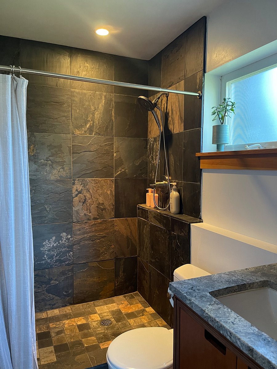 Full bathroom - stone tile shower, vanity has large medicine cabinet and generous storage space. 