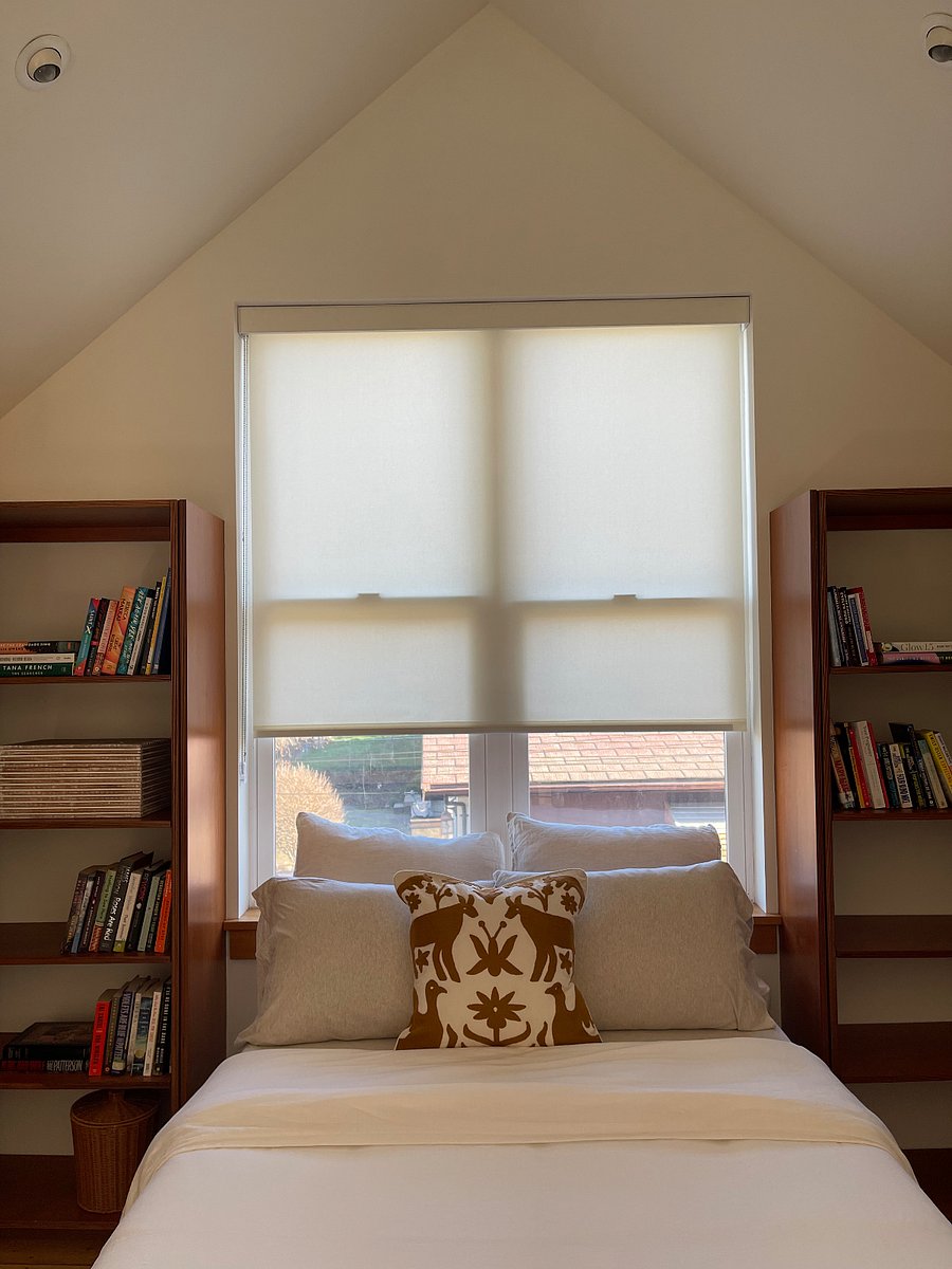 Loft bedroom - built in bookcases and hanging space, full size bed, light filtering shades. 
