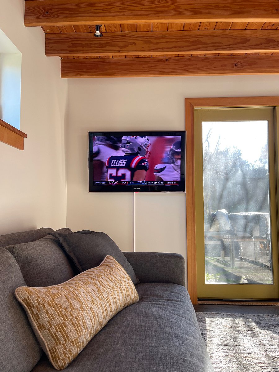 Smart TV on wall across from sectional. 