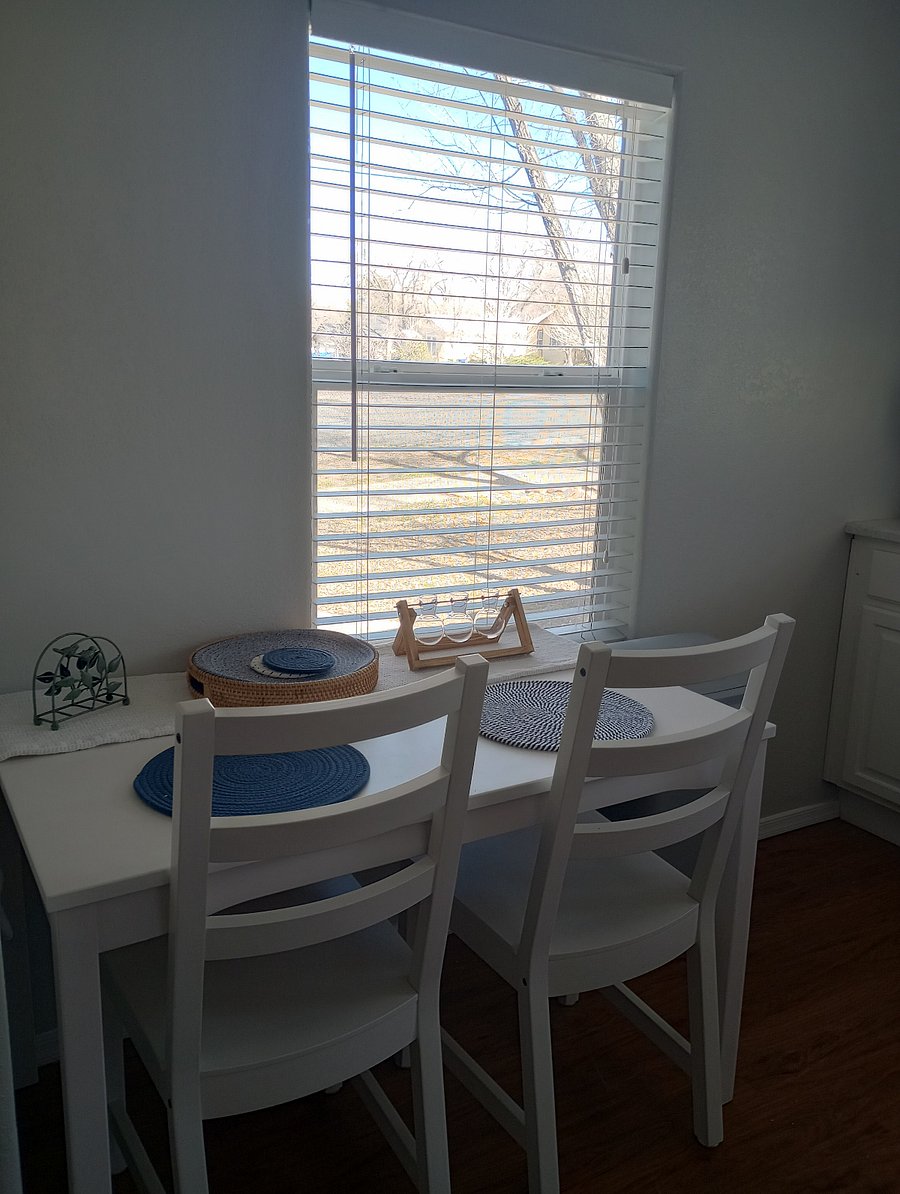Dinning table, extra fold out table and chairs stored in laundry room