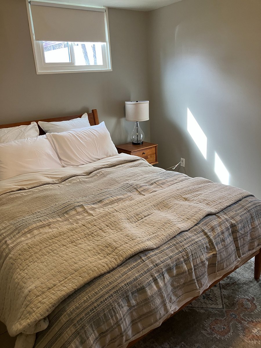 Queen-sized bed with West Elm linens create a restful space. Room darkening shades on the windows to allow for daytime sleep.
