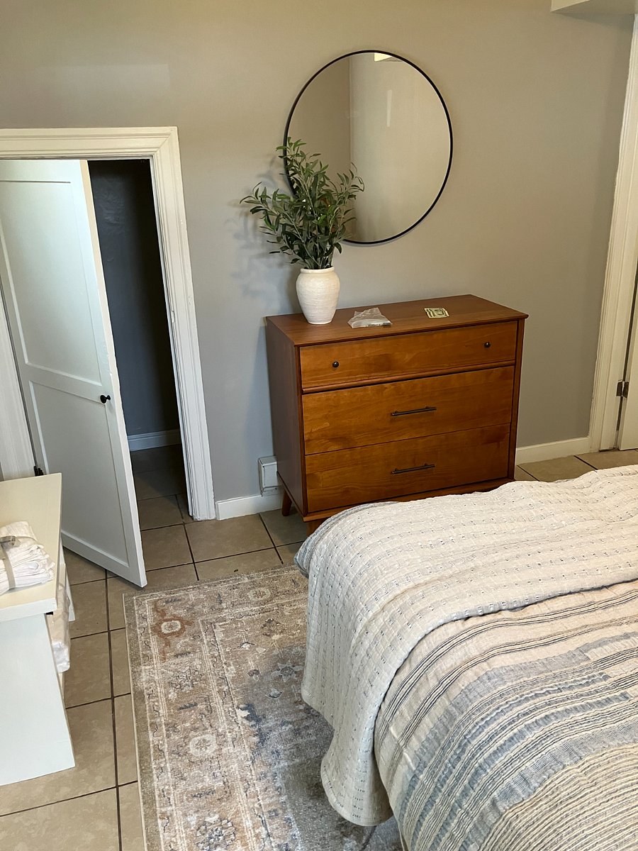 Another small under the stairs closet for hanging clothes, along with a large dresser. A hallway closet provides additional hanging space for longer items.