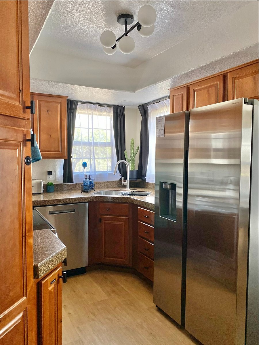 Warm wood tones, abundant natural light, and thoughtful touches create a kitchen that looks beautiful while still being fully functional for everyday cooking.