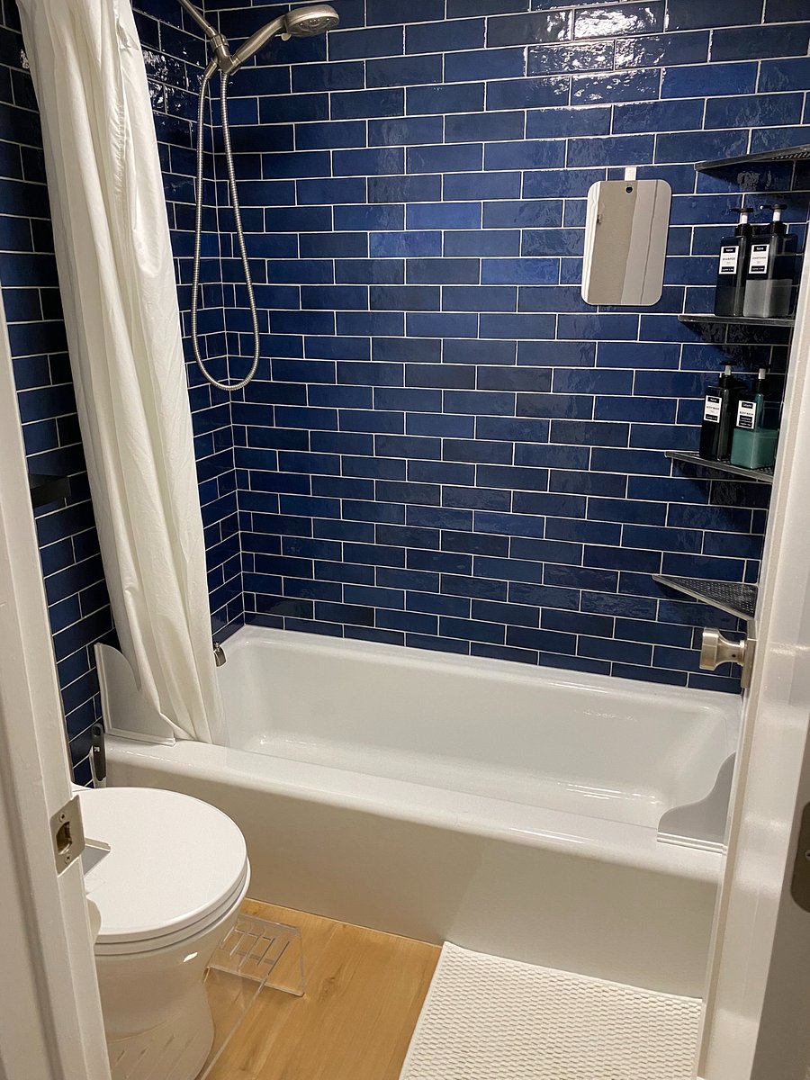From a shower mirror and handheld shower head to a squatty potty and multiple hooks & shelves, this modern bathroom is filled with small details that make a big difference when showering and getting ready.