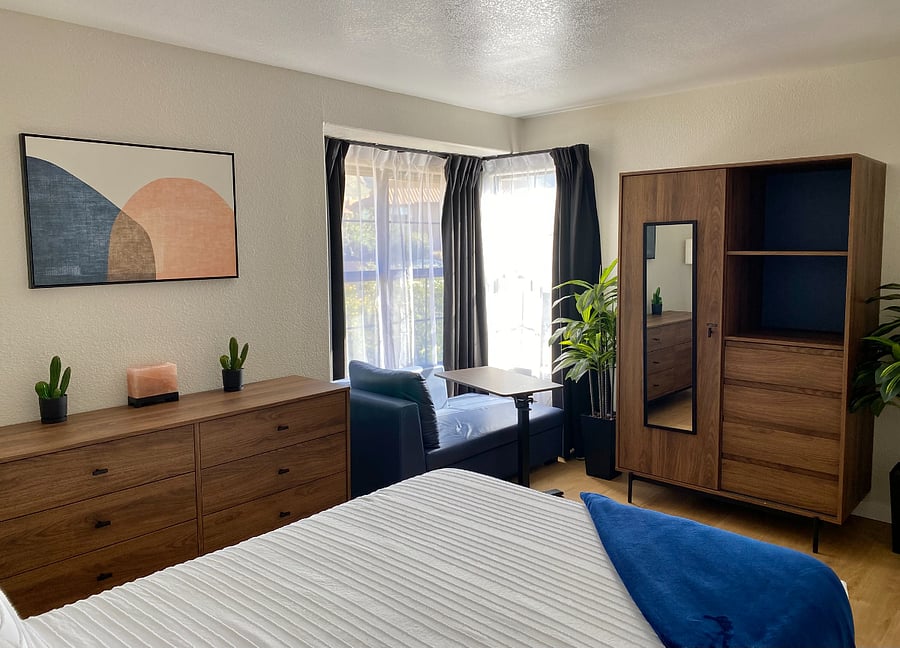 Instead of digging through your suitcase, unpack and make yourself at home with ample drawers, shelving, and hanging space for your belongings.