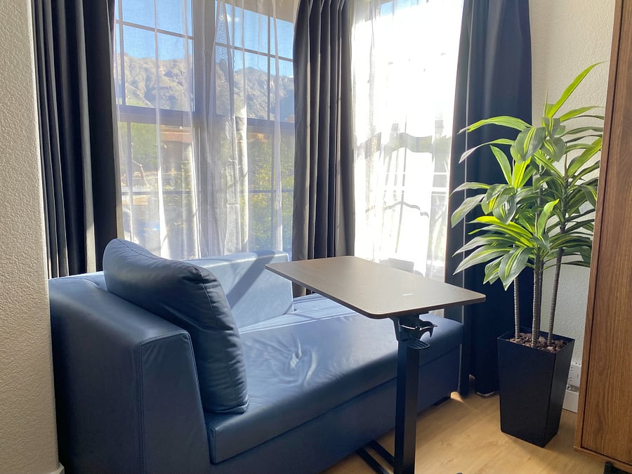 Tucked into a sunlit corner, the chaise lounge and movable table offer a cozy nook to read a novel, catch up on emails, or simply relax and take in the breathtaking mountain view.