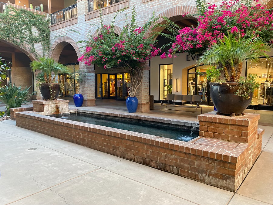 Stroll through La Encantada's beautiful courtyards, where shaded archways, vibrant bougainvillea blooms, and the soft sound of cascading water create a uniquely Tucson experience.