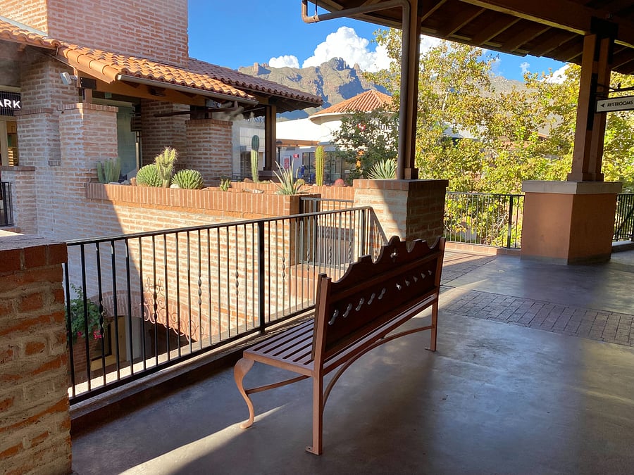 Pause for a moment beneath La Encantada's shaded walkways to admire the charming architecture and stunning mountain views.