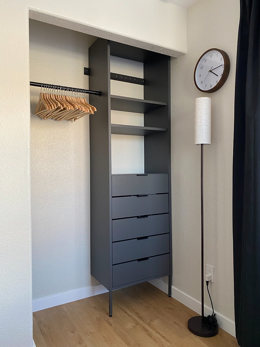 Instead of living out of a suitcase, unpack and organize your belongings with plenty of hanging space, drawers, shelves, and wooden hangers.