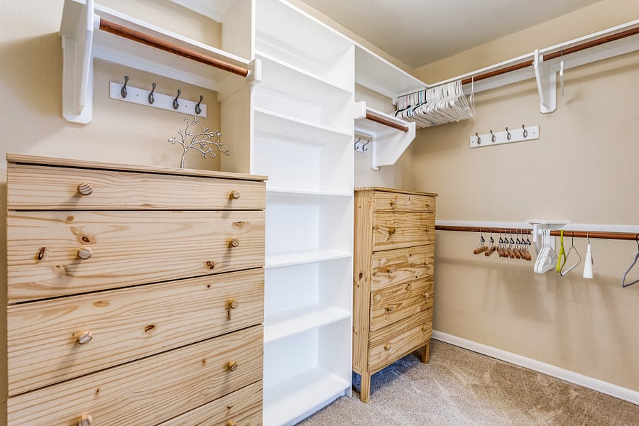 Large walk in closet with dressers, in the primary bedrooml