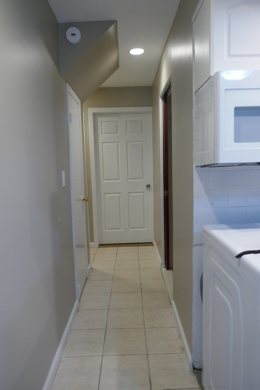 Hallway to full bathroom, and bedrooms.