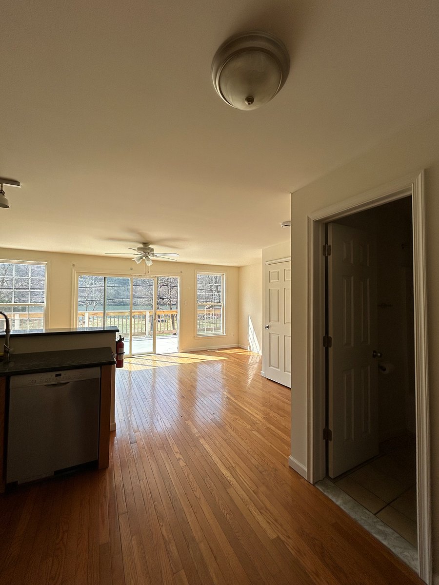 View from main living space, looking outward to private riverfront view from elevated balcony (New furnishings incoming)