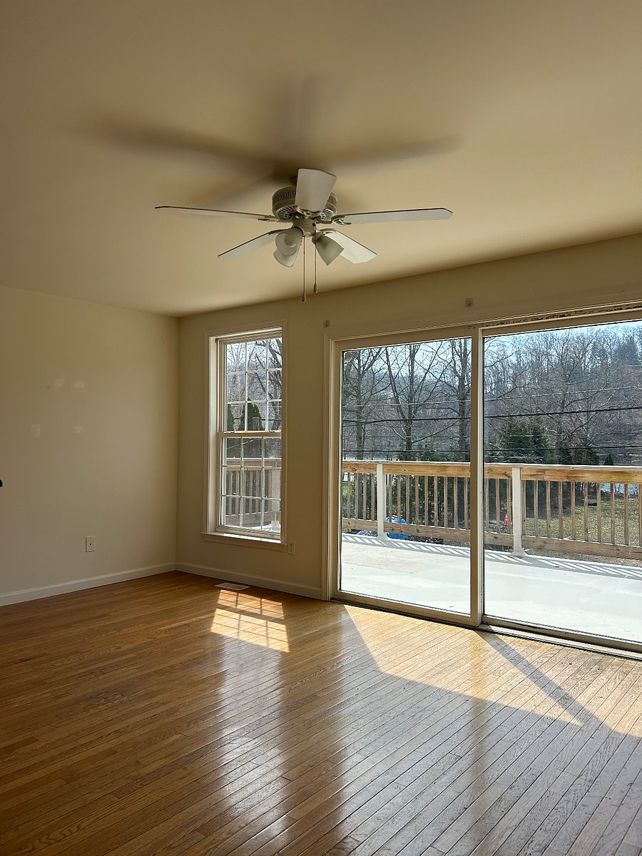 Wall of windows and and sliding glass doors leading to 340 square foot riverfront balcony