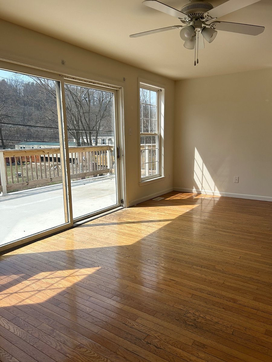 Bright, sun-drenched living area looking out to quiet riverfront
