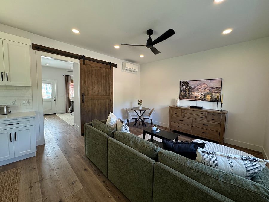 Living room with high ceilings. Ceiling fan and air conditioner/heater.