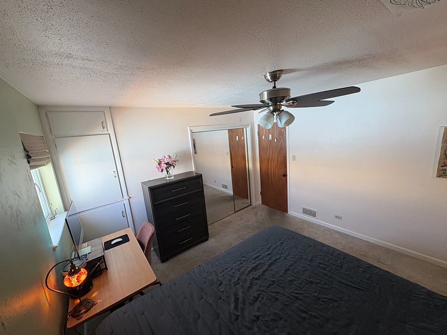 large, spacious primary bedroom with black out curtains, ceiling fan, cali king Purple mattress, ample storage, large closet, standing desk and more!