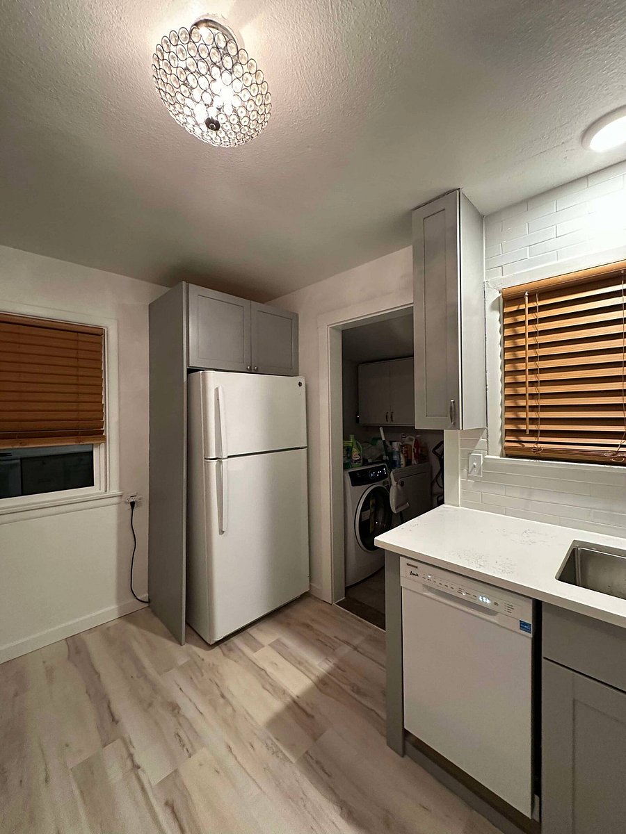 Full size refrigerator, laundry area in mudroom by back entrance